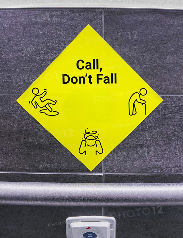 Yellow call for help sign in hospital bathroom