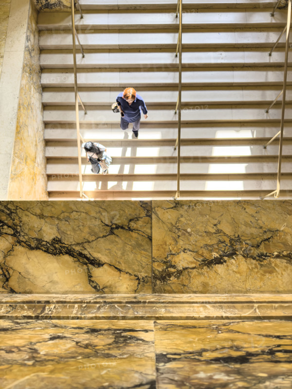 High angle view of two people walking down staircase, Boston Public Library, Boston
