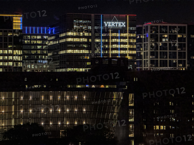 Cityscape featuring Vertex corporate office building at night, Boston