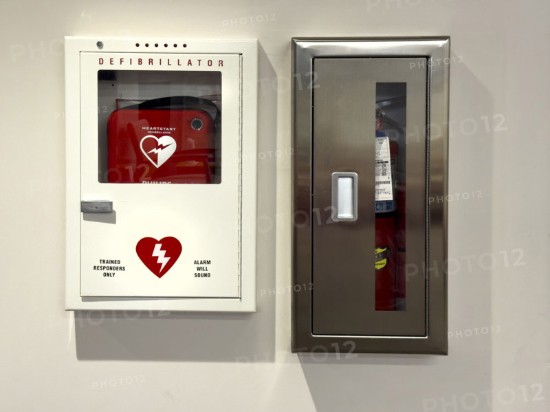 Wall-mounted defibrillator and fire extinguisher