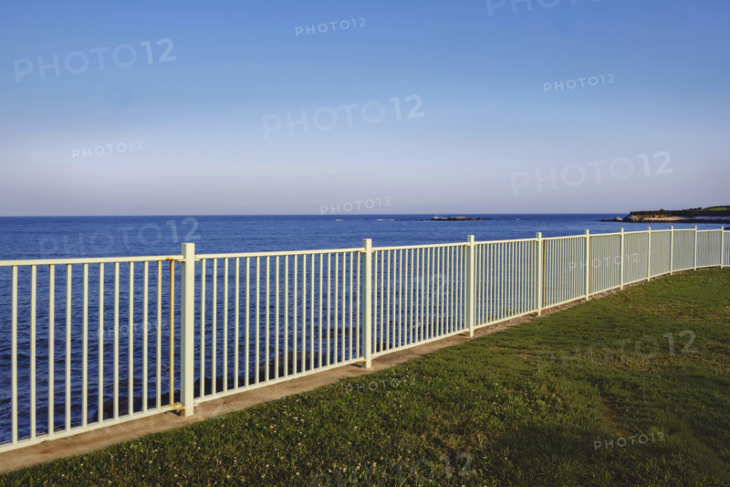 White metal fence along ocean, Newport, Rhode Island, USA