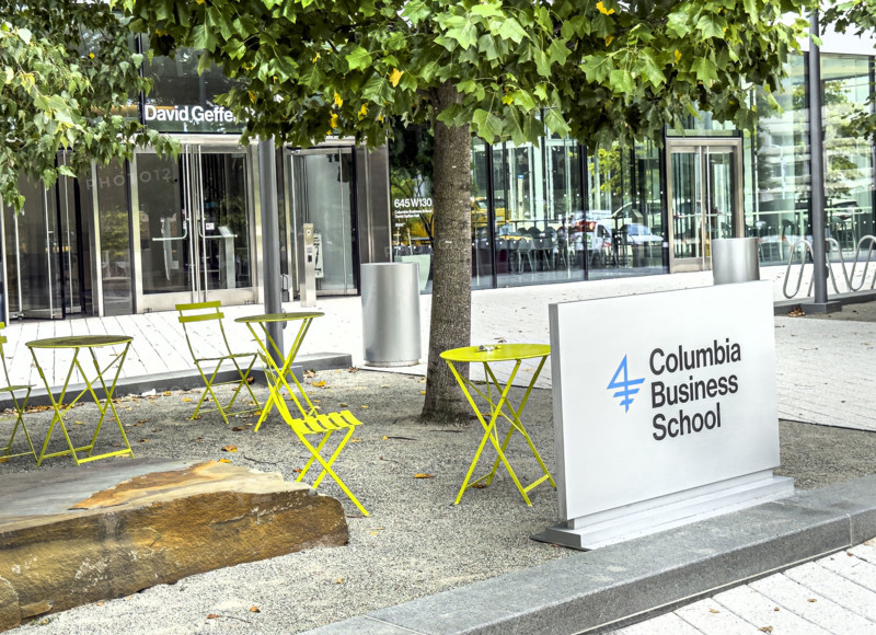 Sign and yellow bistro tables and chairs outside of David Geffen Hall, Columbia University Business School, Columbia University, Manhattanville Campus, 645 West 130th Street, West Harlem, Manhattan, New York City, New York, USA