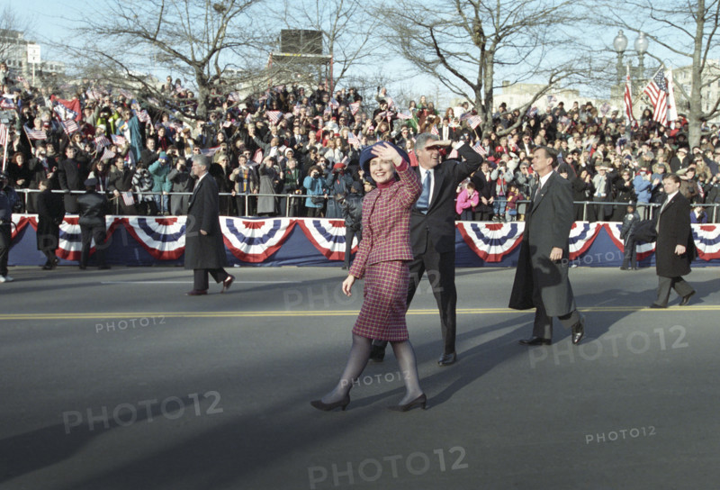 U.S. President Bill Clinton and U.S. First Lady Hillary Rodham Clinton walking along the Inaugural Parade route and waving to the crowd, Washington, D.C., USA, Bob McNeely, White House Photographer, January 20, 1993