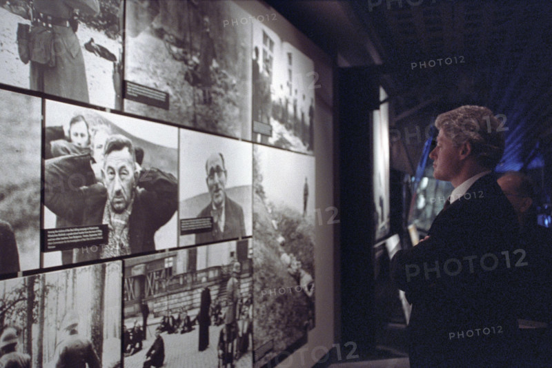 U.S. President Bill Clinton viewing photo exhibit at the Holocaust Museum, Washington, D.C., USA, Ralph Alswang, White House Photographer, April 19, 1993