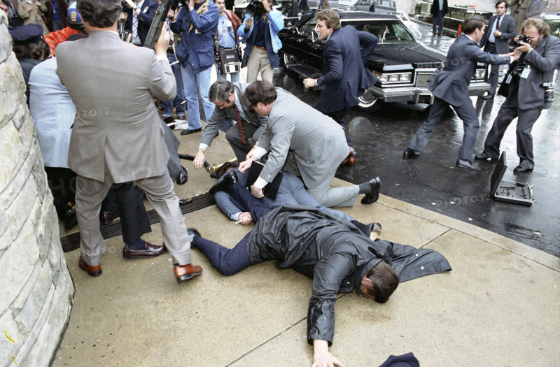 Secret Service agents covering Press Secretary James Brady and police officer Thomas Delahanty during assassination attempt on U.S. President Ronald Reagan, Washington, D.C., USA, President Ronald Reagan White House Photographic Office, March 30, 1981