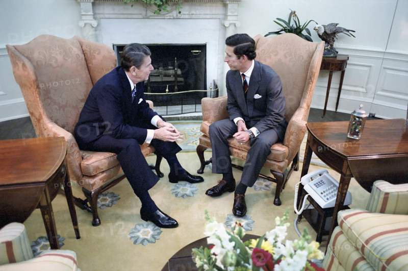 U.S. President Ronald Reagan sitting by fireplace with Prince Charles during visit in the  Oval Office of the White House, Washington, D.C., USA, President Ronald Reagan White House Photographic Office, May 1, 1981