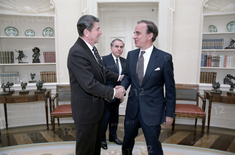 U.S. President Ronald Reagan shaking hands, with Rupert Murdoch as Director of U.S. Information Agency Charles Wick looks on during a meeting in the Oval Office of the White House, Washington, D.C., USA, President Ronald Reagan White House Photographic Office, January 18, 1983