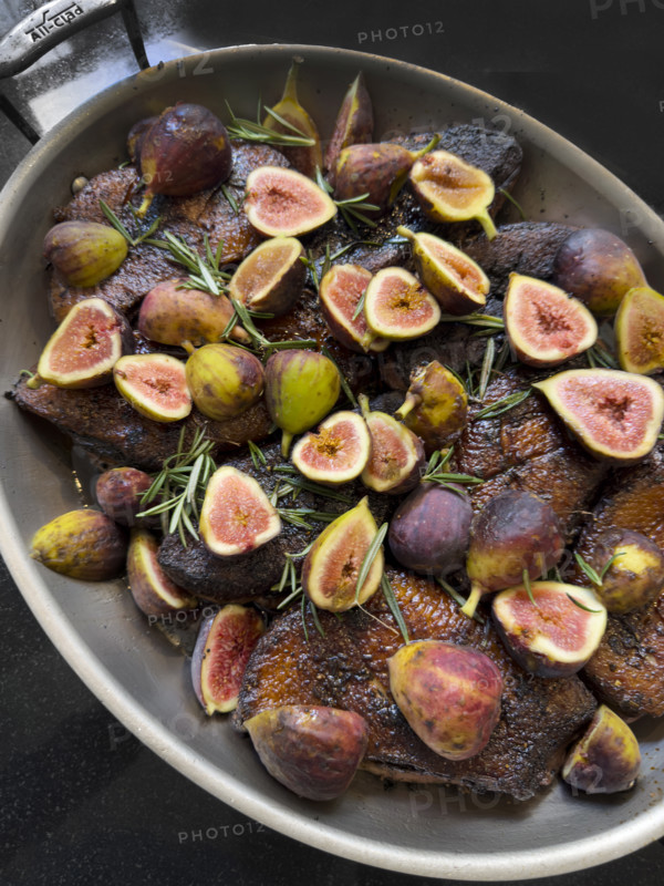 Duck breasts with fresh figs and herbs in pan
