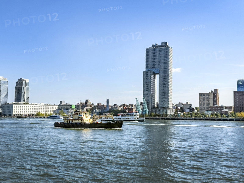 Circle Line ferry and tugboat in East River against Williamsburg cityscape, Brooklyn, New York City, New York, USA