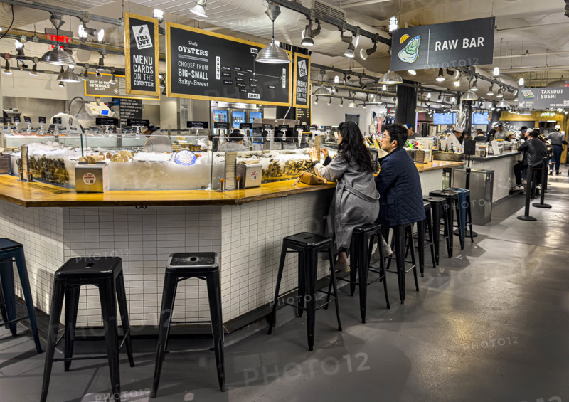 Two people eating at casual restaurant, Lobster Place fish store and restaurant, Chelsea Market, Ninth Avenue, Chelsea, Manhattan, New York City, New York, USA
