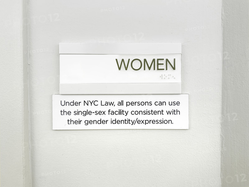 Sign for public bathroom allowing all persons the right to use single-sex facility consistent with their gender identity/expression, New York City, New York, USA