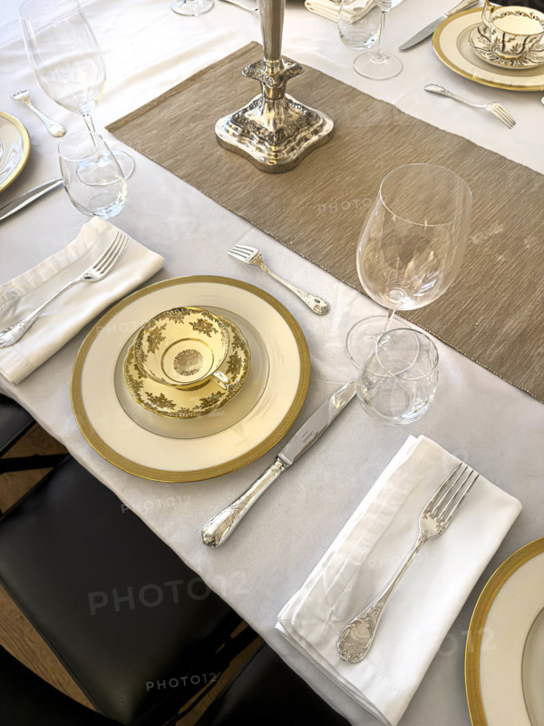 High angle view of dining room table set for formal dinner