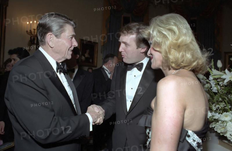 U.S. President Ronald Reagan shaking hands with Donald Trump and Ivana Trump during state visit of King Fahd of Saudi Arabia at the state dinner in the Blue Room of the White House, Washington, D.C., USA, President Ronald Reagan White House Photographic Office, February 11, 1985
