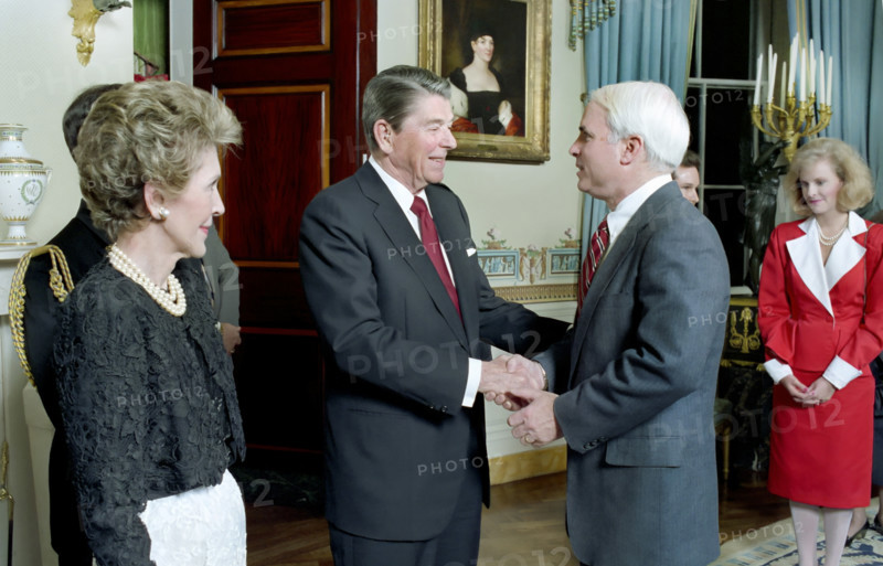 U.S. President Ronald Reagan and U.S. First Lady Nancy Reagan greeting John McCain in the White House Blue Room during a dinner for newly-elected members of The 100th Congress, Washington, D.C., USA, President Ronald Reagan White House Photographic Office, March 3, 1987