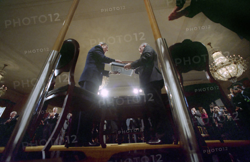 U.S. President Ronald Reagan and Soviet General Secretary Mikhail Gorbachev holding signed INF Treaty, low angle view, White House East Room, Washington, D.C., USA, President Ronald Reagan White House Photographic Office, December 8, 1987