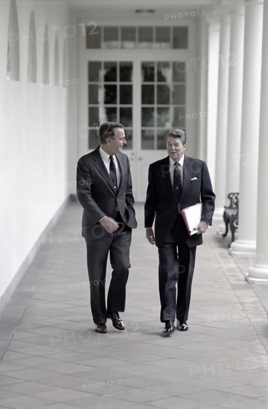 U.S. President Ronald Reagan and U.S. Vice President George H.W. Bush walking along White House Colonnade, Washington, D.C., USA, President Ronald Reagan White House Photographic Office, May 3, 1988