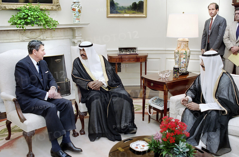 U.S. President Ronald Reagan during working visit of Prime Minister Saad Al-Abdullah Al-Salim Al-Sabah (center) and Crown Prince Jaber Al-Ahmad Al-Sabah (right) of Kuwait, White House Oval Office, Washington, D.C., USA, President Ronald Reagan White House Photographic Office, July 12, 1988