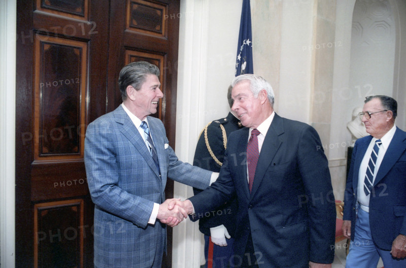 U.S. President Ronald Reagan shaking hands with retired American baseball player Joe DiMaggio at White House baseball hall of fame luncheon, Washington, D.C., USA, President Ronald Reagan White House Photographic Office, March 27, 1981