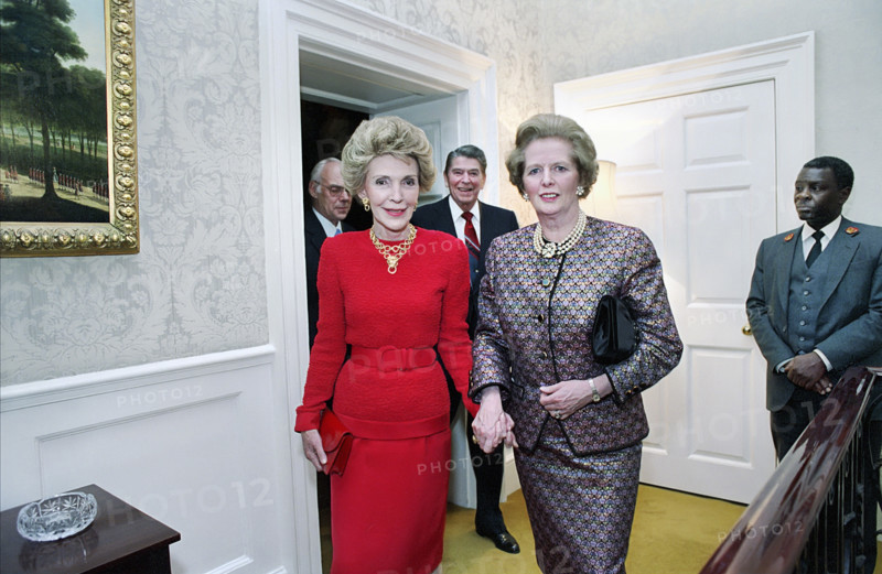 U.S. First Lady Nancy Reagan holding hands with British Prime Minister Margaret Thatcher with U.S. President Ronald Reagan Denis Thatcher in background during dinner at 10 Downing Street, London, England, United Kingdom, President Ronald Reagan White House Photographic Office, June 2, 1988
