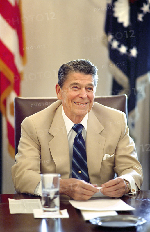 U.S. President Ronald Reagan smiling during meeting with Republican Congressional Leadership in the white House Cabinet Room, Washington, D.C., USA, President Ronald Reagan White House Photographic Office, July 26, 1988