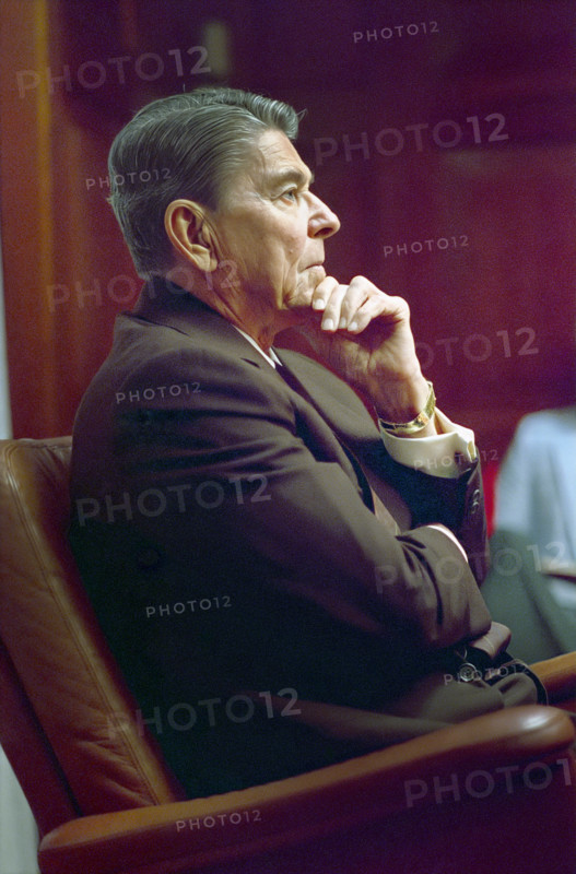 U.S. President Ronald Reagan sitting during a National Security Planning Group (NSPG) meeting in the White House, Situation Room, Washington, D.C., USA, President Ronald Reagan White House Photographic Office, August 12, 1988