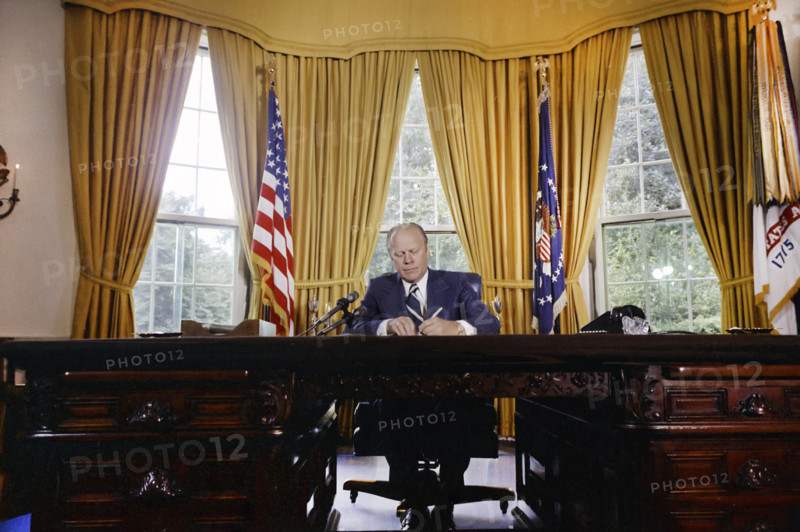 U.S. President Gerald R. Ford signing proclamation granting pardon to former U.S. President Richard Nixon, White House Oval Office, Washington, D.C., USA, Gerald R. Ford White House Photographs, September 8, 1974