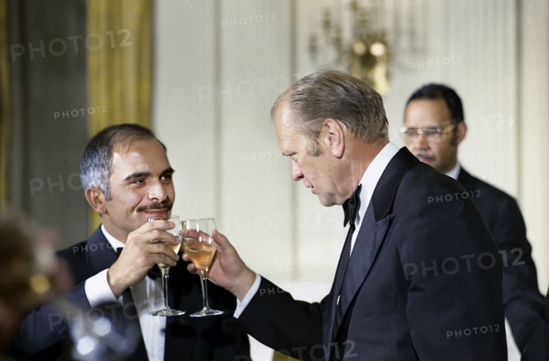 U.S. President Gerald R. Ford and King Hussein of Jordan raising their glasses at stag dinner held in His Majesty's honor, Washington, D.C., USA, Gerald R. Ford White House Photographs, April 29, 1975