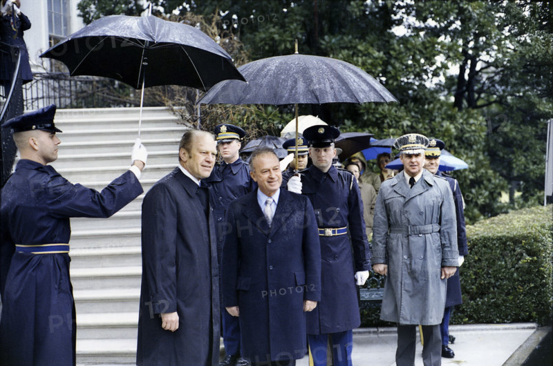 U.S. military guards holding umbrellas over U.S. President Gerald R. Ford and Prime Minister Yitzhak Rabin of Israel during the arrival ceremony for the Prime Minister's state visit, White House, Washington, D.C., USA, Gerald R. Ford White House Photographs, January 27, 1976