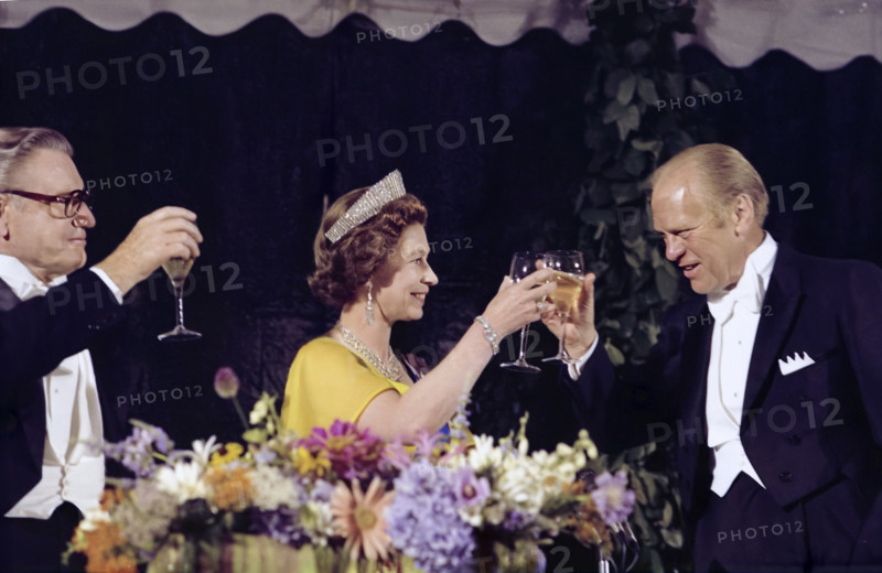 U.S. President Gerald R. Ford, U.S. Vice President Nelson A. Rockefeller, and Queen Elizabeth II of Great Britain raising their glasses in a toast at state dinner honoring Her Majesty and Prince Philip, Washington, D.C., USA, Gerald R. Ford White House Photographs, July 7, 1976