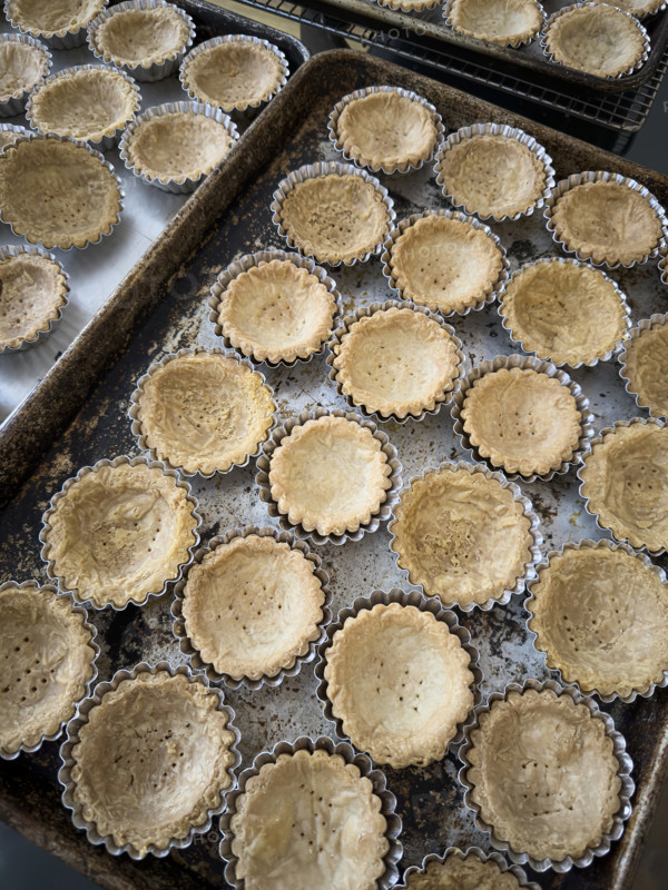 Pre-baked mini tart crusts in baking tin