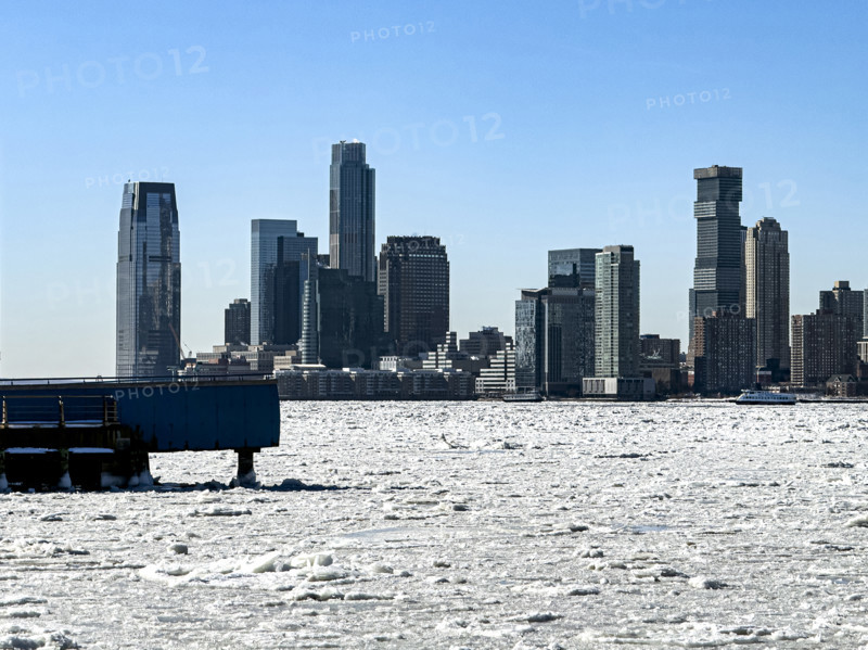 View of Jersey City, New Jersey, USA skyline across frozen Hudson River