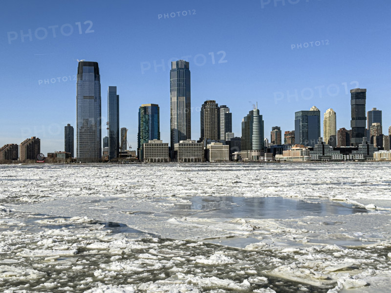 View of Jersey City, New Jersey, USA skyline across frozen Hudson River