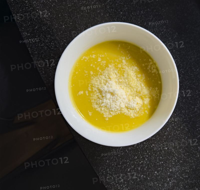 High angle view of a bowl of butternut squash soup sprinkled with parmesan cheese