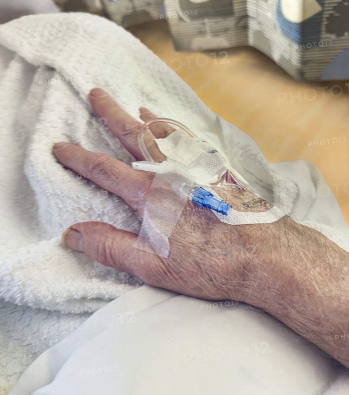 Hospital patient with IV port inserted in his hand