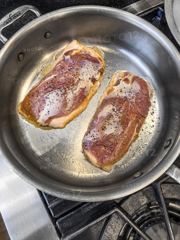 High angle view of sauteed duck breast in pan