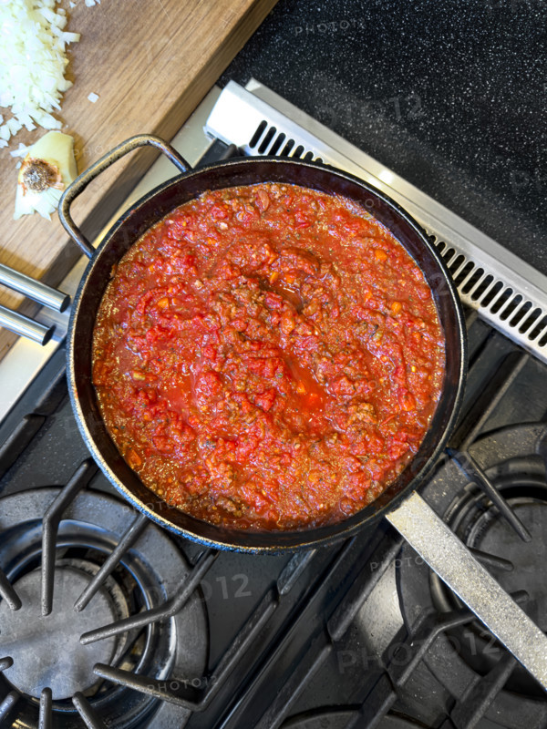 High angle view of bolognese sauce simmering in pot on stove