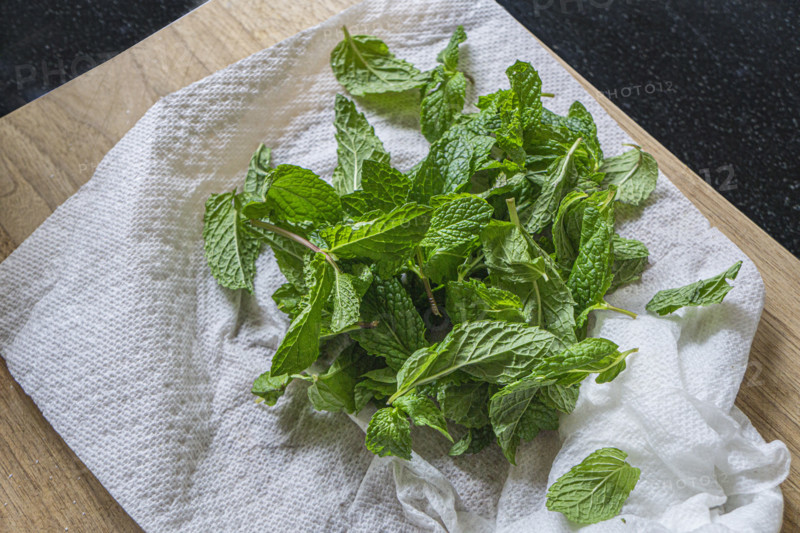 High angle view of fresh mint leaves on cutting board