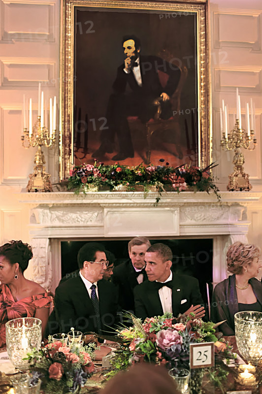 U.S. President Barack Obama and U.S. First Lady Michelle Obama sit with President Hu Jintao of China under a portrait of Abraham Lincoln during State Dinner in White House State Dining Room, Washington, D.C., USA, Pete Souza, Office of White House Photography Office, January 19, 2011