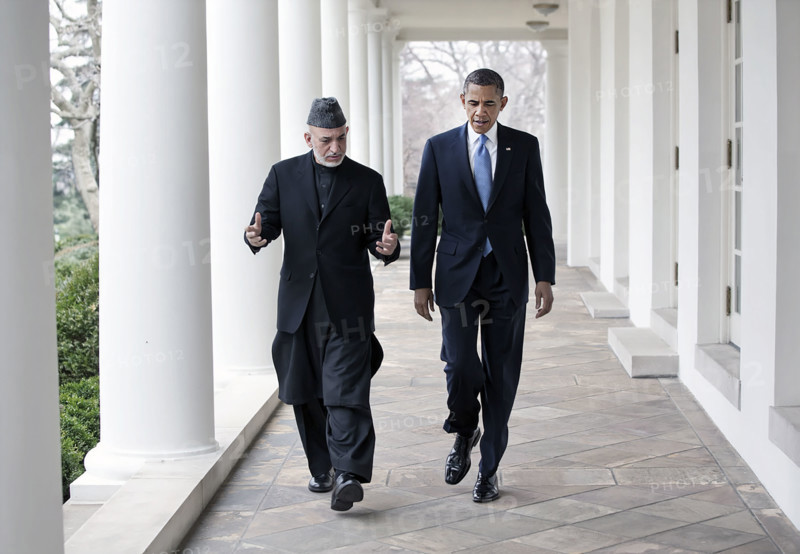 U.S. President Barack Obama and President Hamid Karzai of Afghanistan walking along White House Colonnade following their meeting in the Oval Office, Washington, D.C., USA, Pete Souza, Office of White House Photography, January 11, 2013