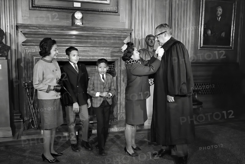 Thurgood Marshall, Associate Justice of the U.S. Supreme Court, assisted with his robes by his wife Cecilia Suyat Marshall, with his family (left to right) sister-in-law Sally Aroba and sons Thurgood Jr. and John, Washington, D.C., USA, Marion S. Trikosko, U.S. News & World Report Magazine Photograph Collection, October 2, 1967