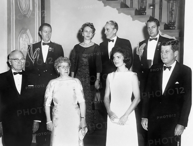 U.S. President John F. Kennedy (right) and U.S. First Lady Jacqueline Kennedy (2nd right) pose with former U.S. President Harry S. Truman (left) and former U.S. First Lady Bess Truman (2nd left) at bottom of the Grand Staircase during White House dinner in their honor. In back row are: Military Aide to the President General Chester V. Clifton, Margaret Truman Daniel, Clifton Daniel, and Naval Aide to the President Captain Tazewell T. Shepard, Washington, D.C., USA, Abbie Rowe, National Parks Service, Harry S. Truman Library, November 1, 1961