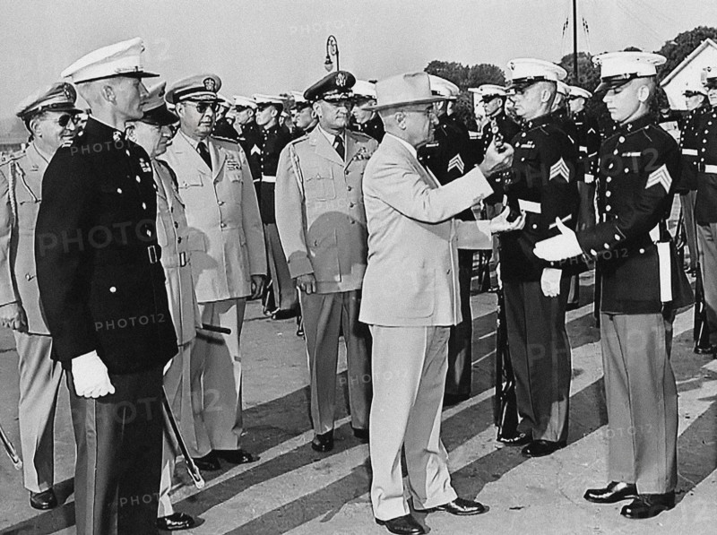 U.S. President Harry S. Truman inspecting rifle of unidentified Marine during visit to U. S. Marine Base. Also left to right: U.S. General Harry H. Vaughan (background), U.S. Admiral Robert L. Dennison and U.S. General Robert B. Landry, Quantico, Virginia, USA, Abbie Rowe, National Parks Service, Harry S. Truman Library, June 15, 1950