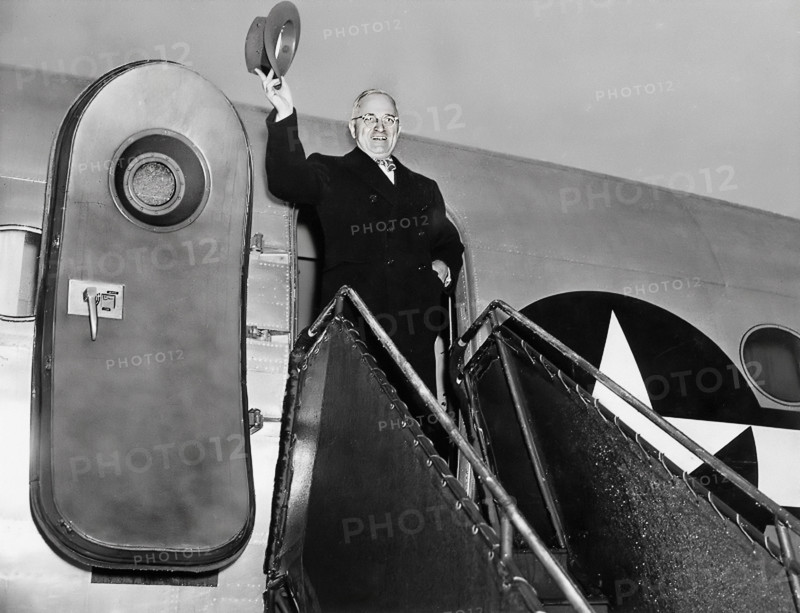 President Harry S. Truman waving his hat from door of his airplane, "Sacred Cow" as he prepares to leave for Christmas trip home to Independence, Missouri, USA, National Airport, Washington, D.C., USA, Abbie Rowe, National Parks Service, Harry S. Truman Library, December 25, 1945