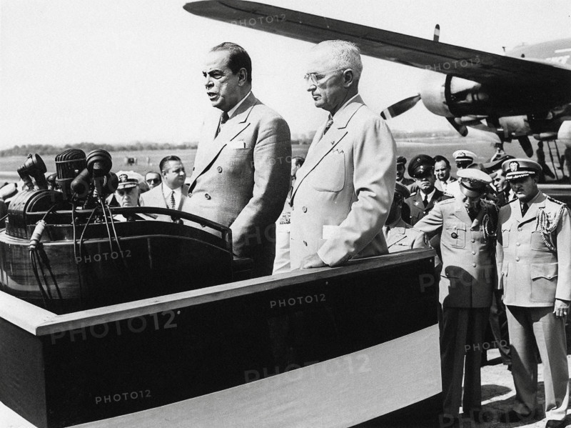 U.S. President Harry S. Truman (center-right) standing beside Romulo Gallegos (center-left), President of Venezuela, as he speaks at National Airport, Washington, D.C., USA, Abbie Rowe, National Parks Service, Harry S. Truman Library, July 1, 1948