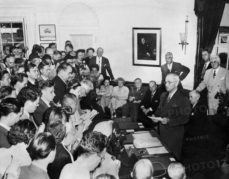 U.S. President Harry S. Truman (standing at desk) announcing surrender of Japan to assembled reporters, White House, Washington, D.C., USA, Abbie Rowe, National Parks Service, Harry S. Truman Library, August 14, 1945