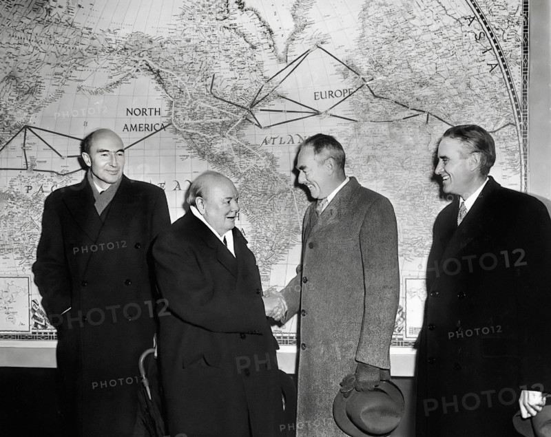 British Prime Minister Winston Churchill (left center) shaking hands with U.S. Secretary of State Dean Acheson (right center) in front of  large map of world as Director of Mutual Security Agency, W. Averell Harriman (right) and unidentified man look on, Washington, D.C., USA, Abbie Rowe, National Parks Service, Harry S. Truman Library, January 8, 1953