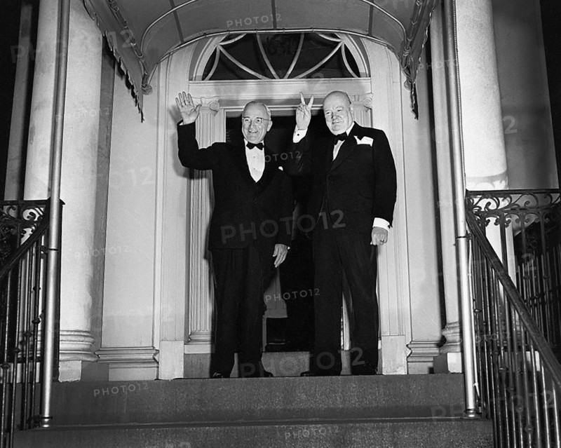 British Prime Minister Winston Churchill (right) flashing his "V for Victory" sign and U.S. President Harry S. Truman (left) waving outside Blair House, Washington, D.C., USA, Abbie Rowe, National Parks Service, Harry S. Truman Library, March 24, 1949