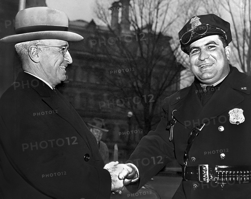 U.S. President Harry S. Truman shaking hands with an unidentified police officer while attending dedication ceremony at George Washington National Masonic Memorial, Alexandria, Virginia, USA, Abbie Rowe, National Parks Service, Harry S. Truman Library, February 22, 1950