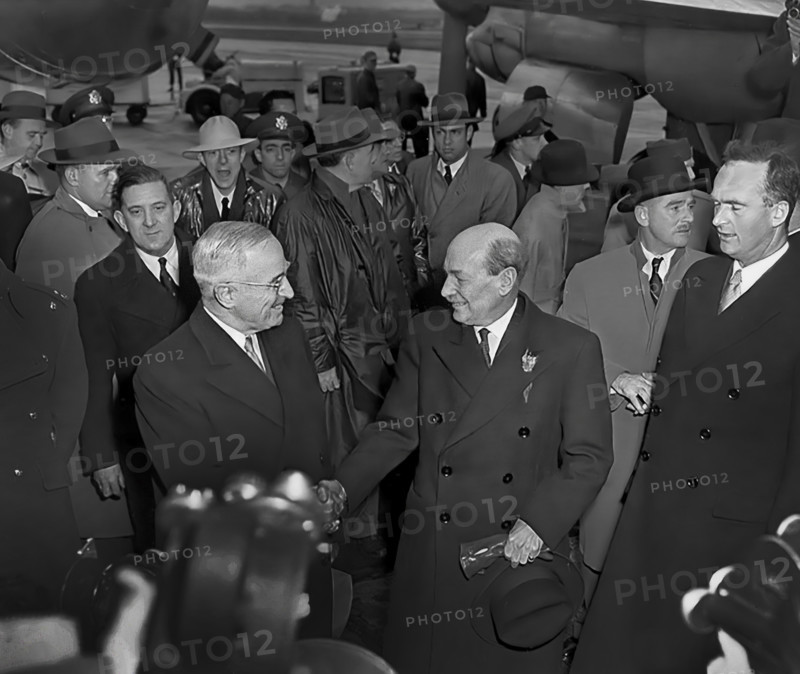 U.S. President Harry S. Truman (foreground, left) greeting British Prime Minister Clement Attlee (foreground, right) at Washington National Airport, upon Attlee's arrival for talks on the Korean crisis, Washington, D.C., USA, Abbie Rowe, National Parks Service, Harry S. Truman Library, December 4, 1950