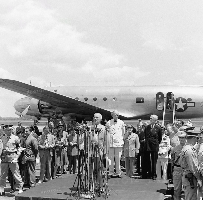 U.S. President Harry S. Truman speaking at ceremony marking departure of U.S. Secretary of State James Byrnes for Paris Peace Conference, as Secretary Byrnes (rear of platform, right), Senator Tom Connally (rear of platform, left) of Texas, and others look on, Washington National Airport, Washington, D.C., USA, Abbie Rowe, National Parks Service, Harry S. Truman Library, July 27, 1946